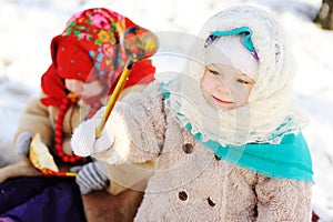 Two little girls in the Russian shawls against the backdrop of s