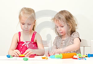 Two little girls sculpting