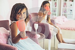 Two little girls in spa enjoying together and having a party