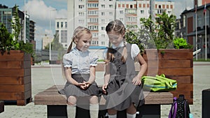 Two little girls talking at schoolyard