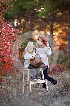 Two little girls walk outdoors in the Park during the Golden autumn