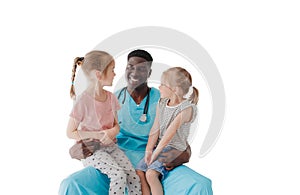 two little happy girls are sitting on the lap of their family doctor and having fun chatting. an African-American male
