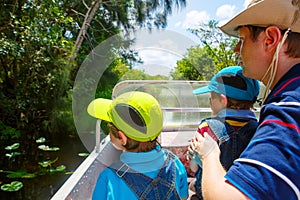 Two little kids boys and father making air boat tour in Everglades Park