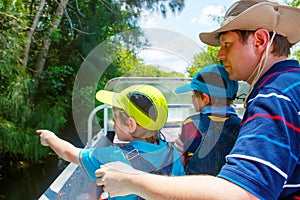 Two little kids boys and father making air boat tour in Everglades Park