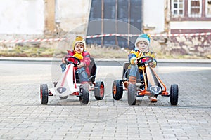 Two little kids boys having fun with toy race cars