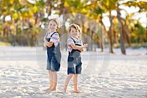 Two little kids boys having fun on tropical beach