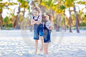 Two little kids boys having fun on tropical beach