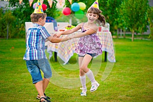 Two little kids dancing roundelay