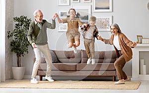 Two little kids enjoying weekend time with energetic grandparents