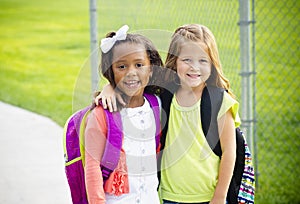 Two little kids going to school together