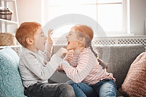 Two little kids having fight at home.