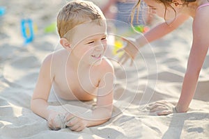 Two little kids having fun on a beach