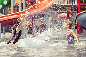 Two little kids playing in the swimming pool