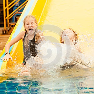 Two little kids playing in the swimming pool