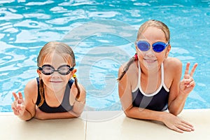 Two little kids playing in the swimming pool