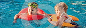 Two little kids playing in the swimming pool BANNER, LONG FORMAT