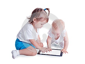 Two little kids playing with tablet computer