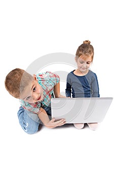 Two little kids using a laptop