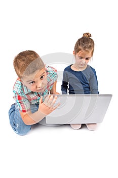 Two little kids using a laptop