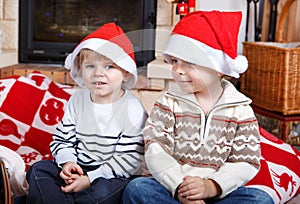 Two little sibling boys being happy about christmas present