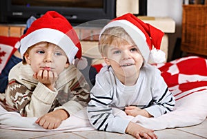 Two little sibling boys being happy about christmas present