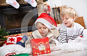 Two little sibling boys being happy about christmas present