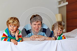 Two little sibling kid boys and dad having fun in