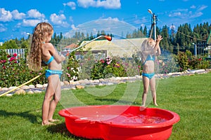 Two little sisters frolicing, splashing and having