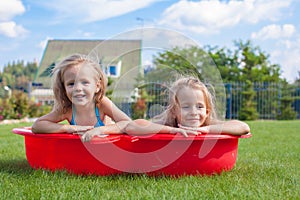 Two little sisters frolicing and splashing in