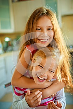 Two little sisters fun laughing