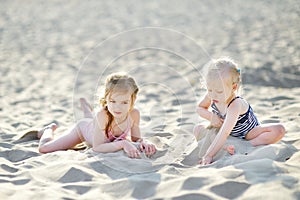 Two little sisters having fun on a beach