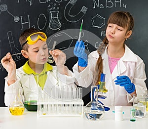 Two little students on chemistry lesson in lab