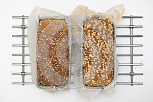 Two loaves of fresh bread on the steel trivet