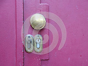 Two Lock Keyholes on Purple Metal Door