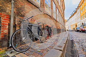 Two locked bicycycles in Copenhagen colorful old town street