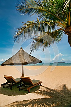 Two lonely loungers on the deserted beach of Hainan Island.