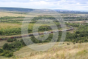 Two long freight trains pass each other. Aerial photo