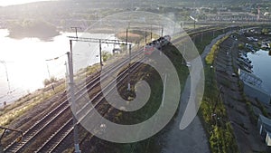 Two long freight trains pass each other. Aerial photo