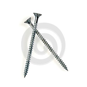 Two long self tapping iron screws with flat head, macro close-up isolated on white background.