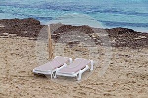 Two lounge chairs on the beach on an autumn day. Mediterranean Sea, Spain