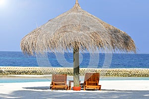 Two lounges on a beautiful white beach