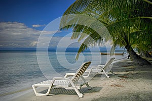 Two lounging chairs on beach