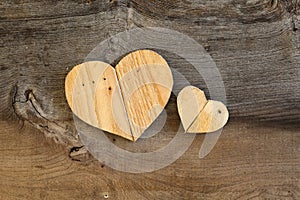 Two Love Valentines wooden hearts on old Elm background