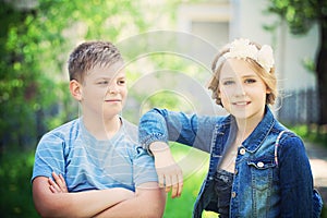 Two Lovely Children Outdoor. Young Boy Looks at Girl