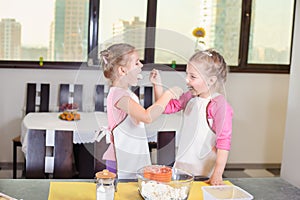 Two lovely children preparing a cake