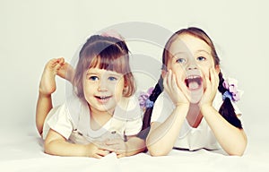 Two lovely little girls playing on the floor