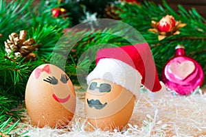 Two lovers celebrate Christmas . Unusual eggs with the muzzle. T