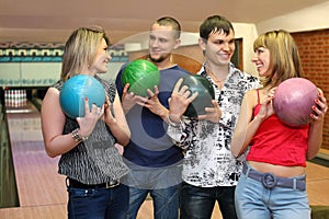 Two in lovers couple stand with balls for bowling