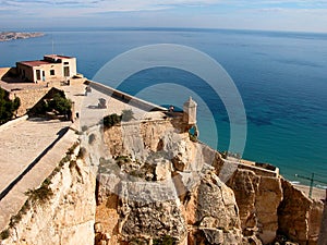 Two lovers embrace overlooking the sea from a castle in spain