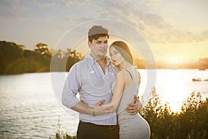 Two lovers embrassing on sunset photo